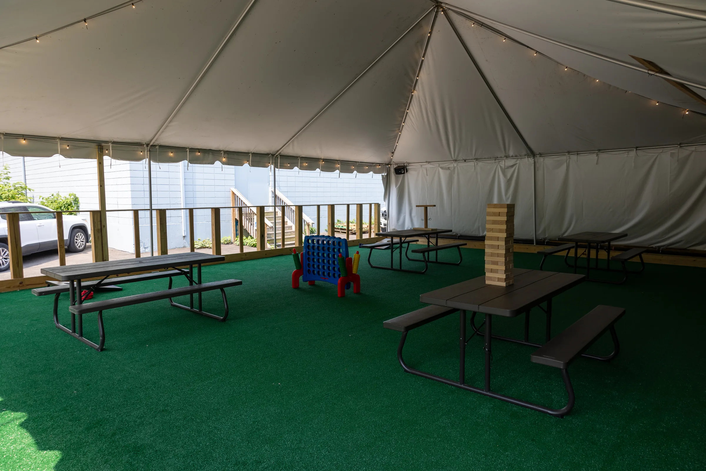 The covered beer garden with picnic tables and lawn games