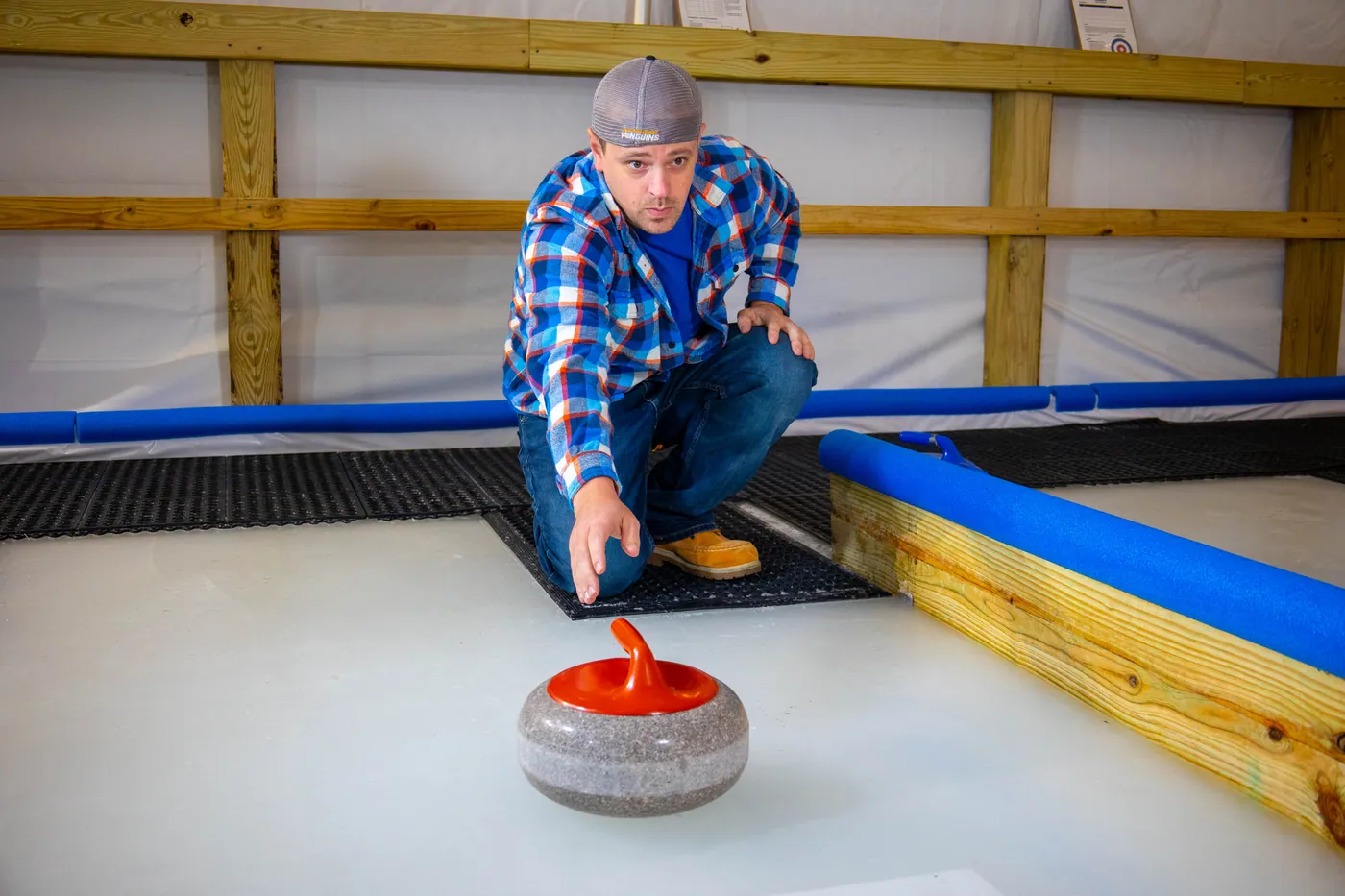 A player releasing a stone down the ice